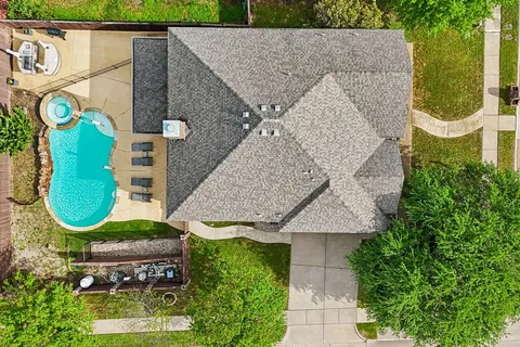 an aerial view of a house with a swimming pool