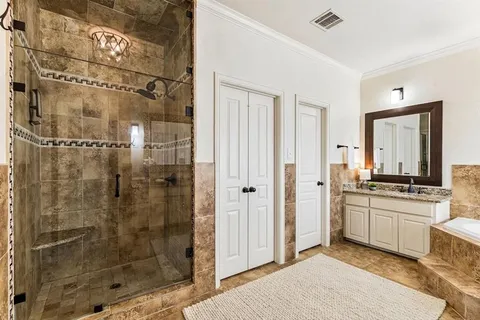 a bathroom with a granite countertop sink a mirror and a shower