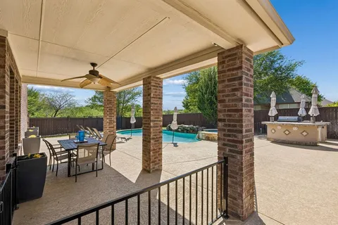 a view of a patio with a table and chairs