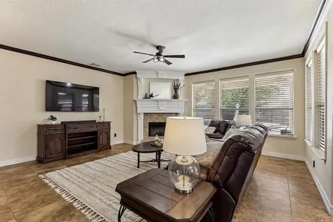a living room with furniture a flat screen tv and a fireplace