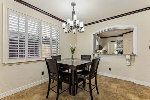 a view of a dining room with furniture and a chandelier