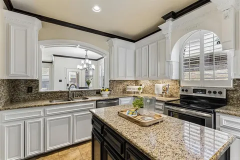 a kitchen with sink stove and cabinets