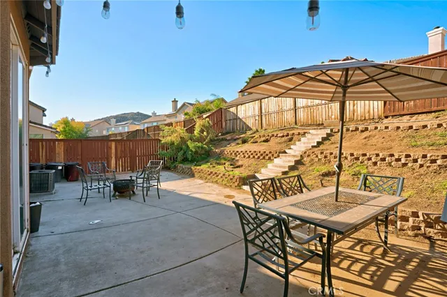 a view of a terrace with furniture and umbrella
