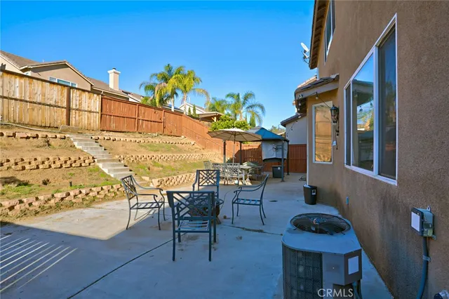 a view of a patio with couches table and chairs and potted plants