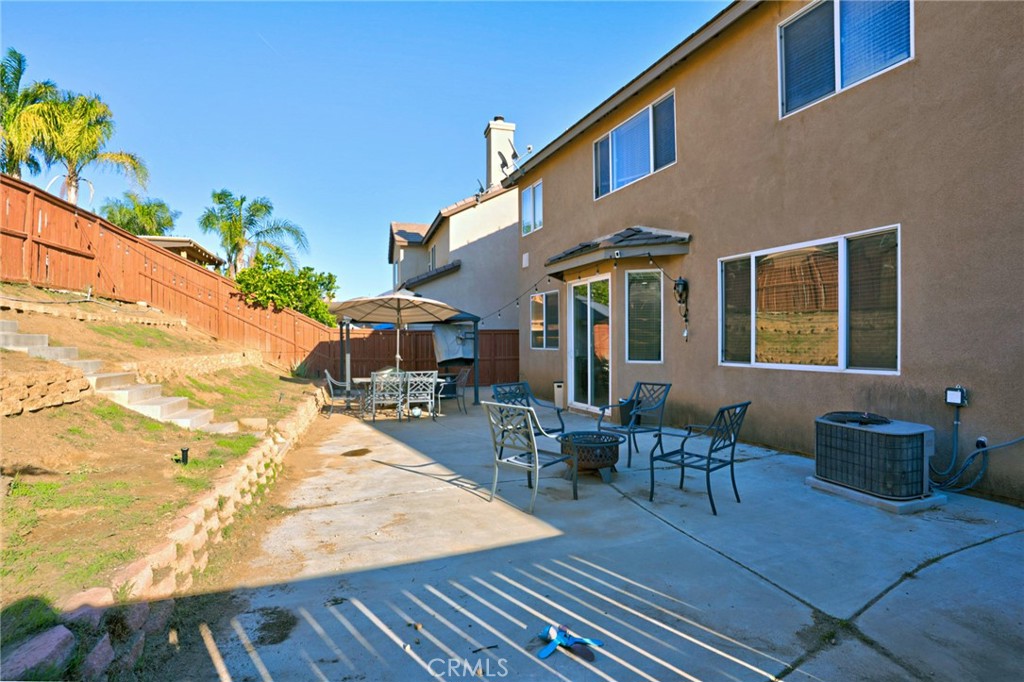 3902 Bluff Street Perris, CA 92571 - Photo 21 of 44 a view of a patio with couches table and chairs and potted plants