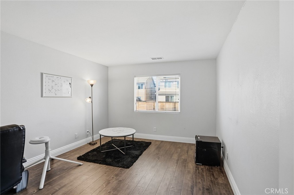 3902 Bluff Street Perris, CA 92571 - Photo 23 of 44 a view of a workspace with wooden floor and a window