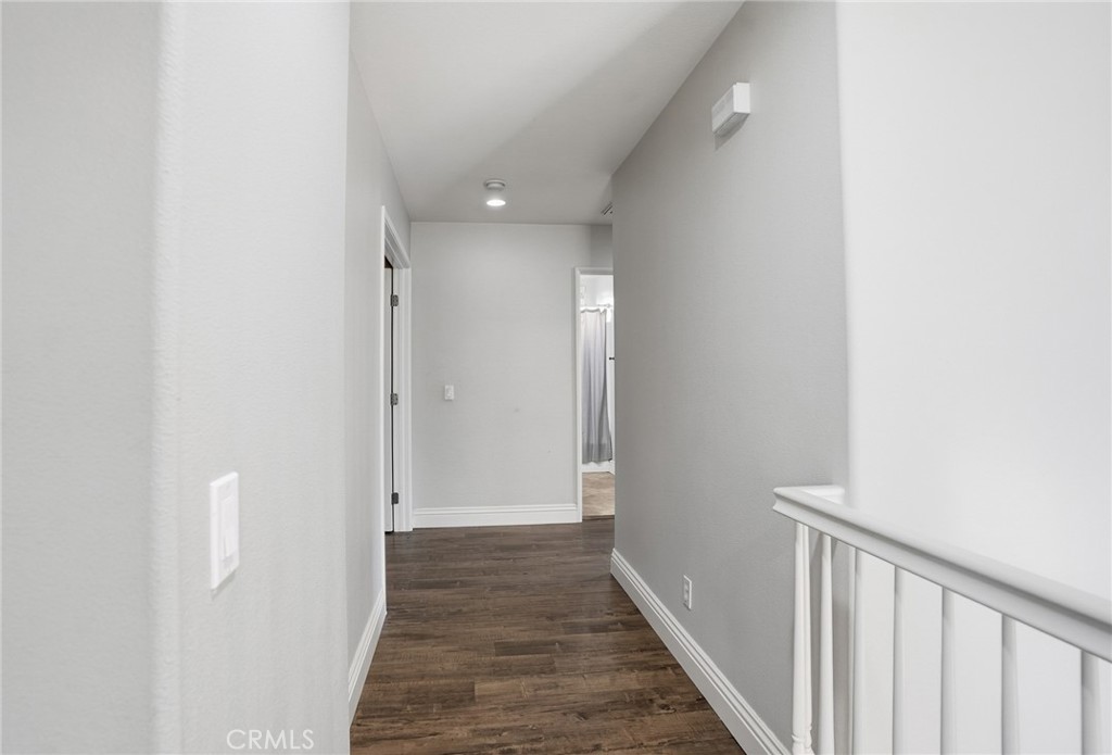 3902 Bluff Street Perris, CA 92571 - Photo 25 of 44 a view of a hallway with wooden floor