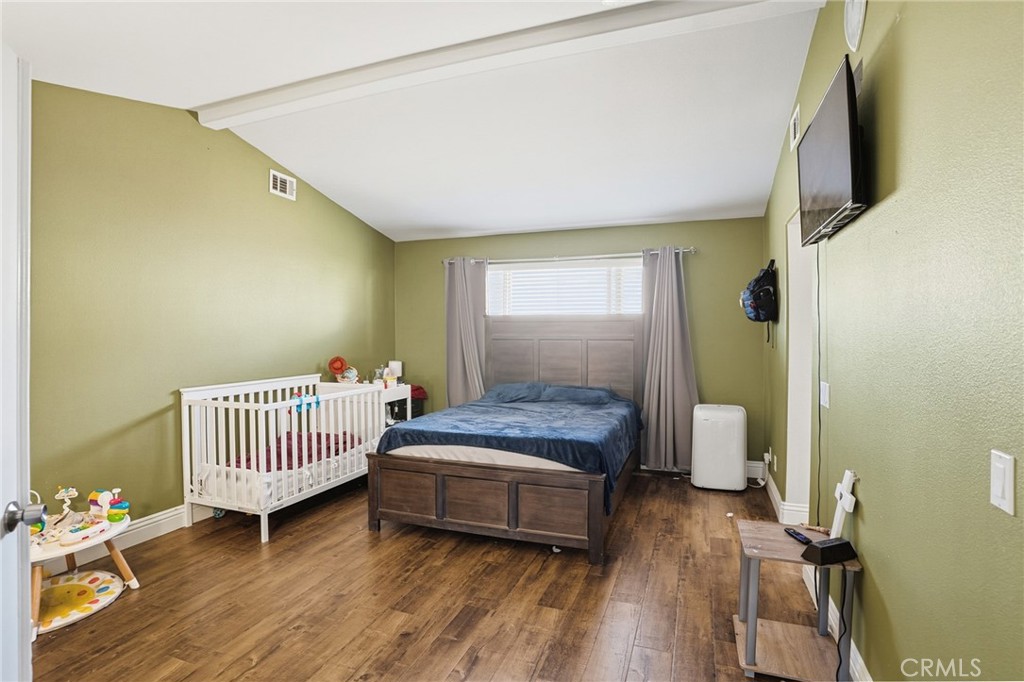 3902 Bluff Street Perris, CA 92571 - Photo 26 of 44 a bedroom with a bed and wooden floor