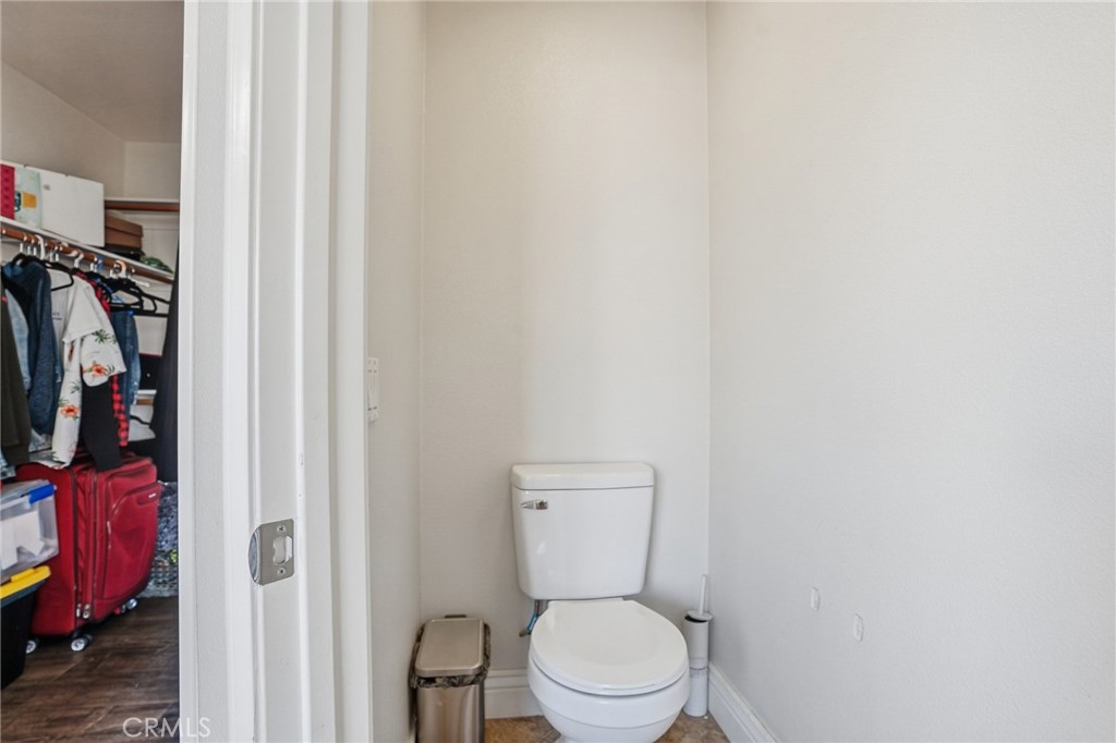 3902 Bluff Street Perris, CA 92571 - Photo 30 of 44 a bathroom with a toilet and a shower curtain