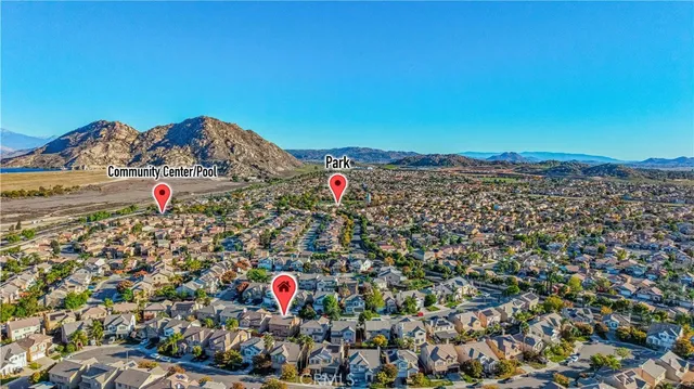 an aerial view of a house with a yard and lake view