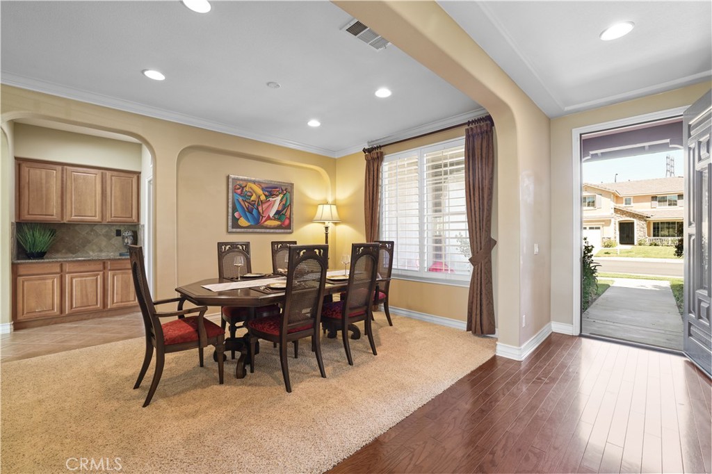 35107 Hogan Drive Beaumont, CA 92223 - Photo 11 of 47 a view of a dining room with furniture window and wooden floor