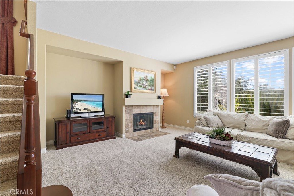 35107 Hogan Drive Beaumont, CA 92223 - Photo 19 of 47 a living room with furniture a fireplace and a flat screen tv
