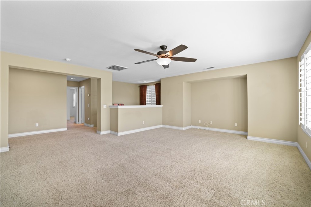 35107 Hogan Drive Beaumont, CA 92223 - Photo 25 of 47 a view of an empty room with a ceiling fan