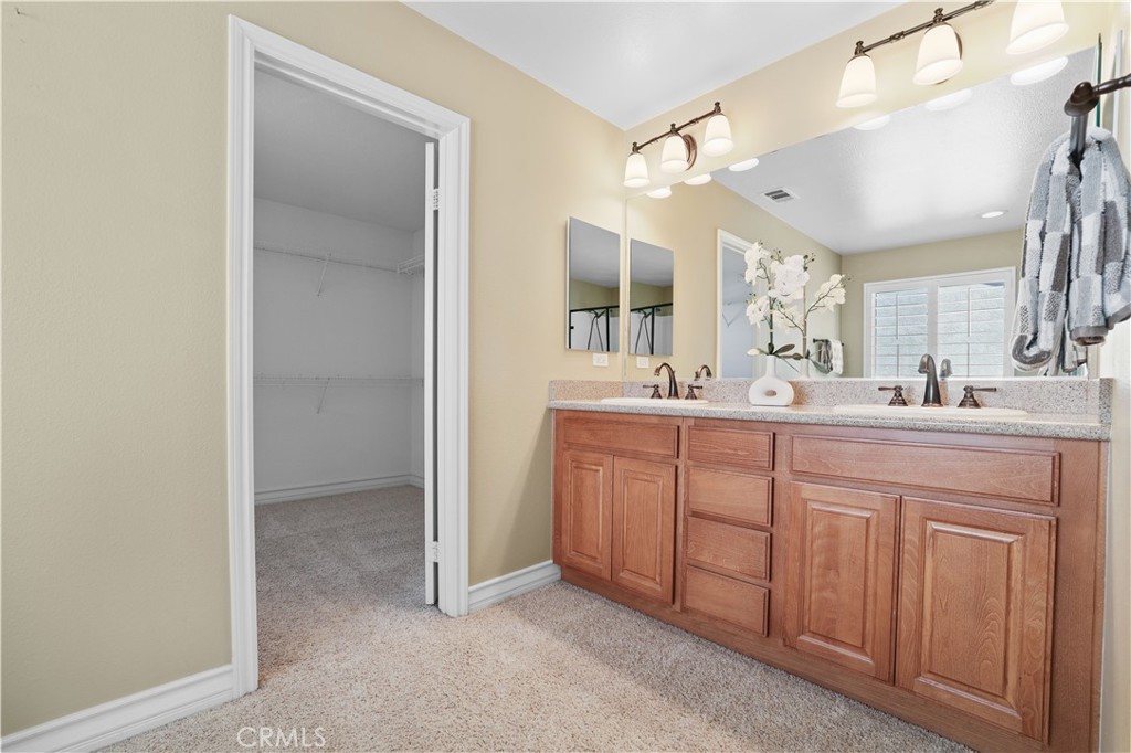 35107 Hogan Drive Beaumont, CA 92223 - Photo 32 of 47 a bathroom with a double vanity sink and mirror