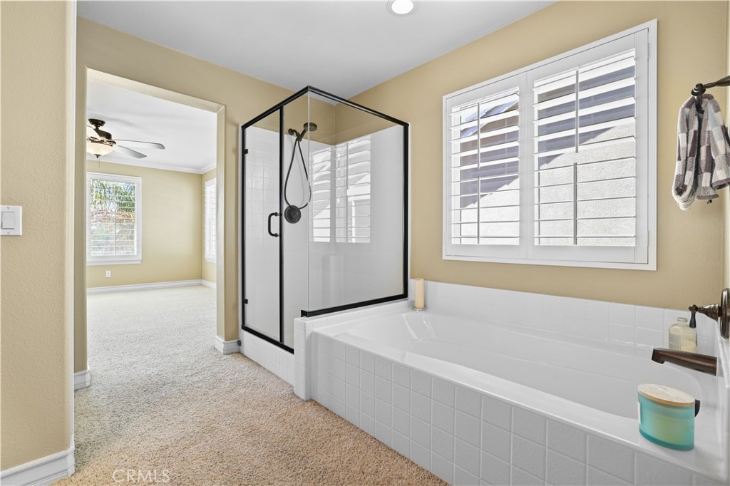 35107 Hogan Drive Beaumont, CA 92223 - Photo 35 of 47 a spacious bathroom with a tub shower and mirror