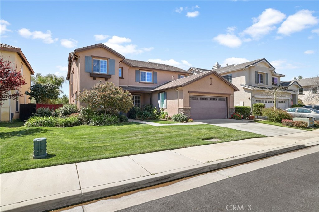 35107 Hogan Drive Beaumont, CA 92223 - Photo 4 of 47 a front view of a house with a yard and garage