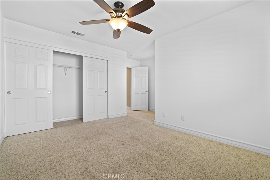 35107 Hogan Drive Beaumont, CA 92223 - Photo 41 of 47 an empty room with a ceiling fan and a fan