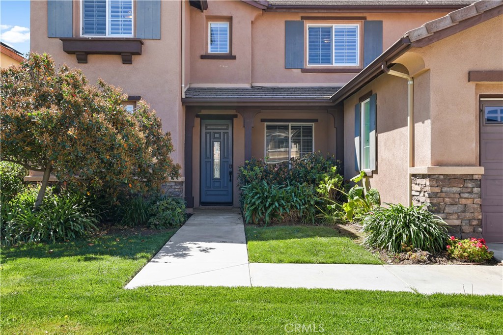 35107 Hogan Drive Beaumont, CA 92223 - Photo 5 of 47 a front view of a house with a yard