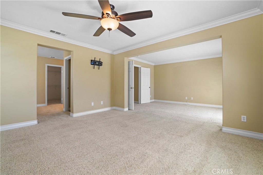 35107 Hogan Drive Beaumont, CA 92223 - Photo 7 of 47 an empty room with ceiling fan and a ceiling fan