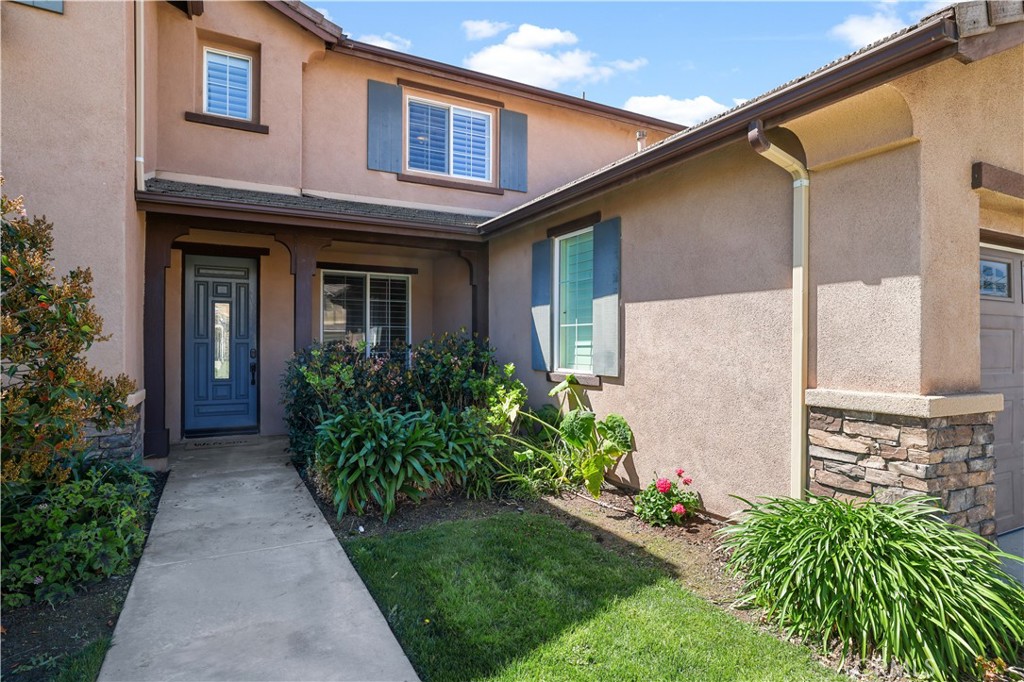 35107 Hogan Drive Beaumont, CA 92223 - Photo 8 of 47 a front view of a house with garden