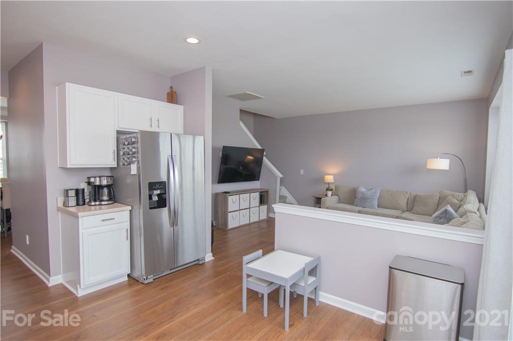 7613 Bluff Point Lane Denver, NC 28037 - Photo 2 of 20 a kitchen with white cabinets and stainless steel appliances