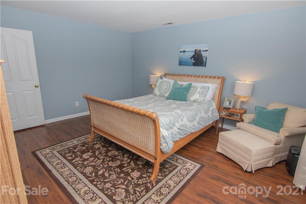 7613 Bluff Point Lane Denver, NC 28037 - Photo 11 of 20 a bedroom with a bed rug and wooden floor