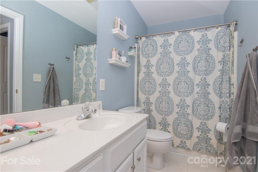7613 Bluff Point Lane Denver, NC 28037 - Photo 12 of 20 a bathroom with a sink toilet and shower