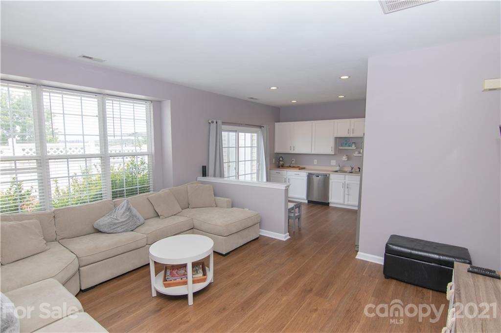 7613 Bluff Point Lane Denver, NC 28037 - Photo 13 of 20 a living room with furniture and a large window