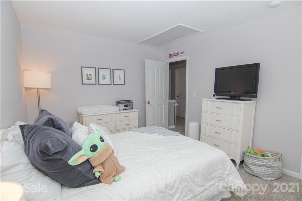 7613 Bluff Point Lane Denver, NC 28037 - Photo 7 of 20 a bedroom with a bed and a flat screen tv