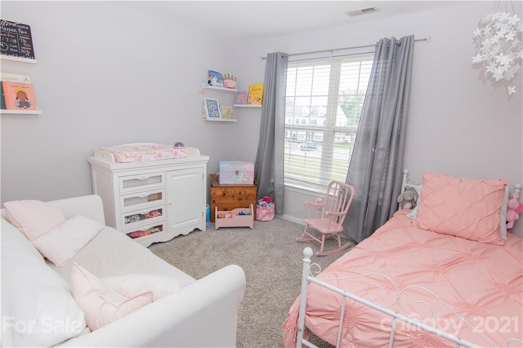 7613 Bluff Point Lane Denver, NC 28037 - Photo 8 of 20 a bedroom with a bed and a window