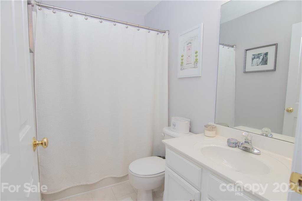 7613 Bluff Point Lane Denver, NC 28037 - Photo 9 of 20 a bathroom with a granite countertop sink toilet and a mirror