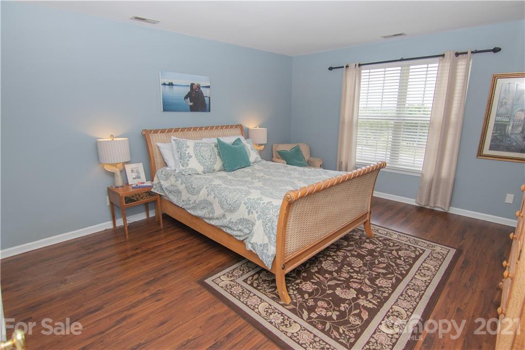 7613 Bluff Point Lane Denver, NC 28037 - Photo 10 of 20 a bed sitting in a bedroom next to a window