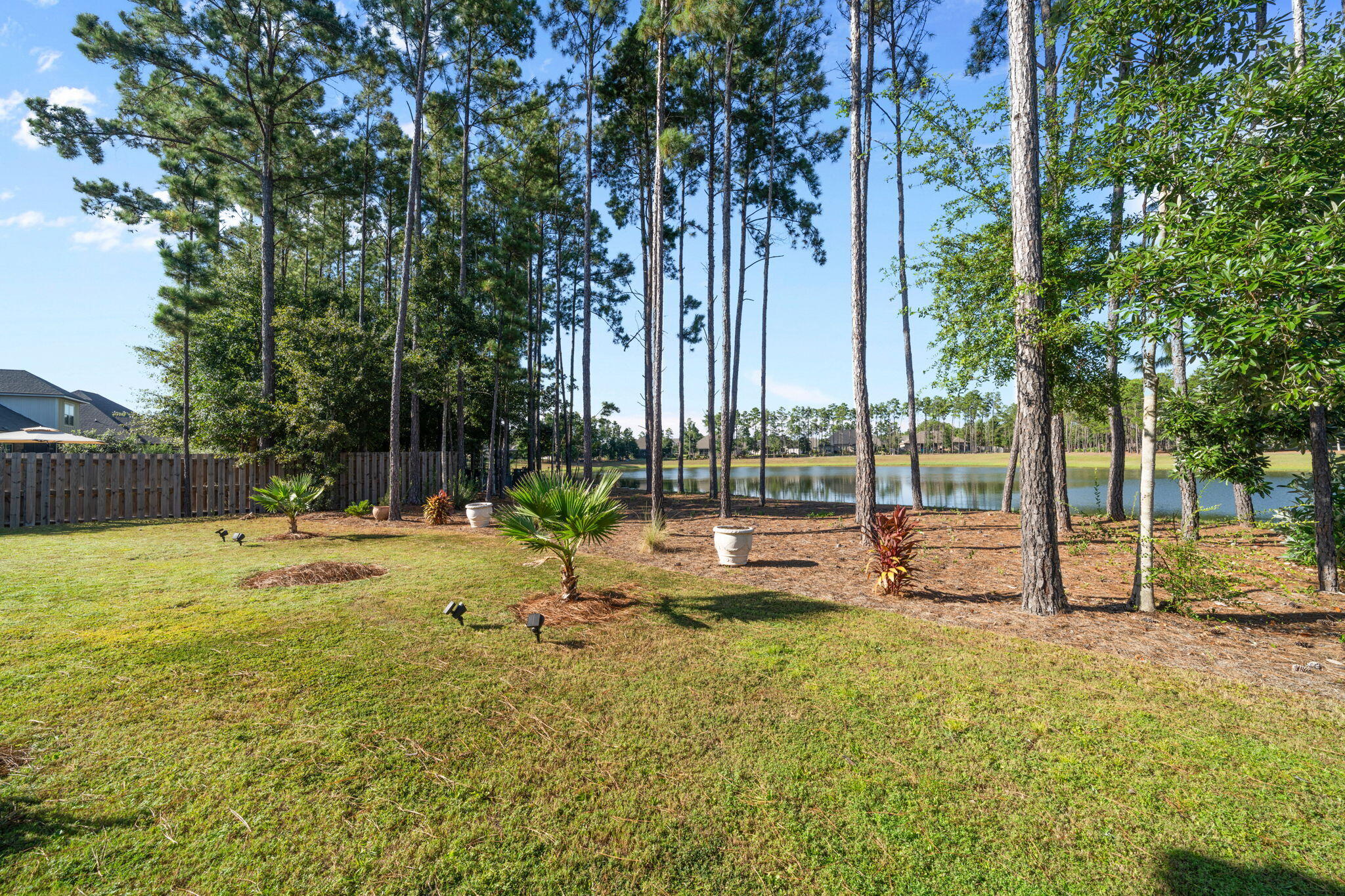 142 Mill Pond Cove Freeport, FL 32439 - Photo 60 of 109 a view of a swimming pool with lawn chairs and large trees
