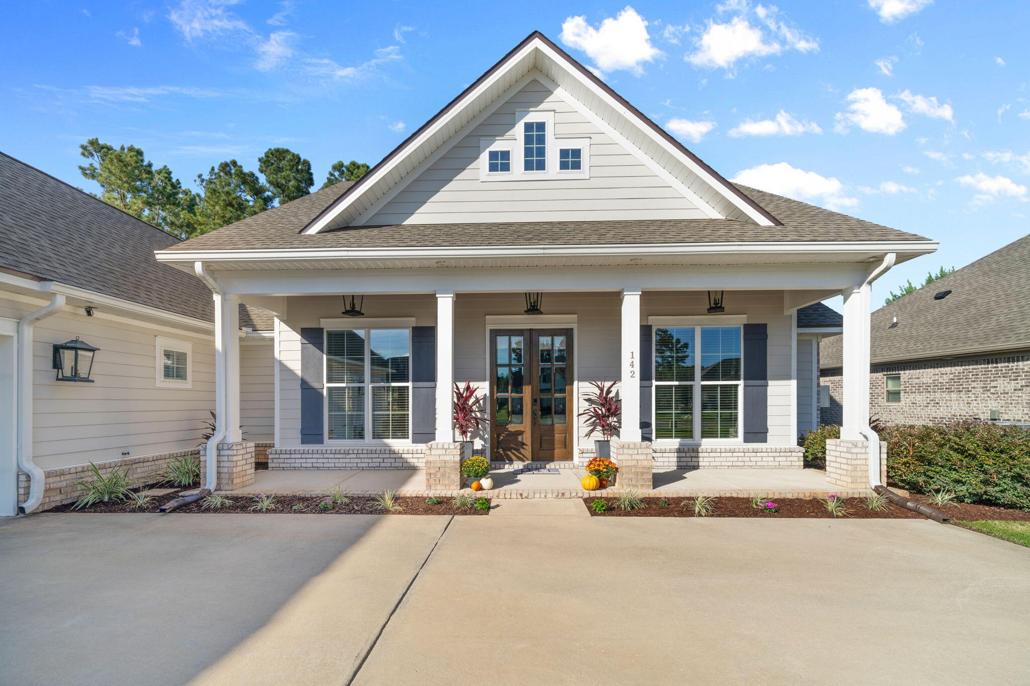 142 Mill Pond Cove Freeport, FL 32439 - Photo 8 of 109 a front view of a house with a yard