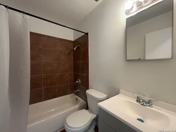 a bathroom with a toilet a sink and bathtub