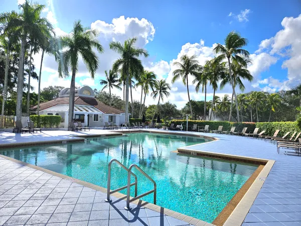a view of a swimming pool with a table and chairs