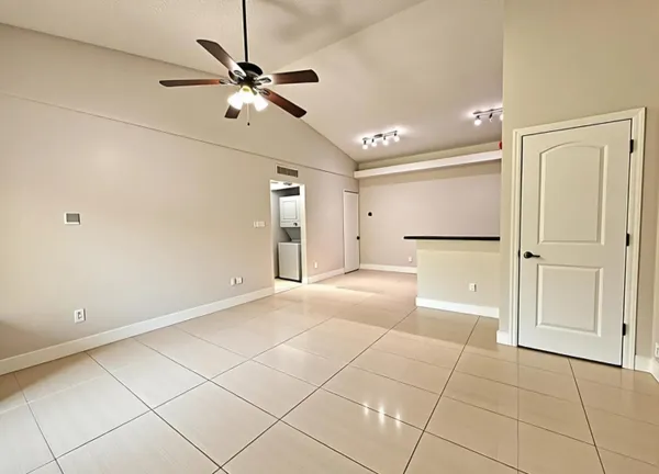 a view of a livingroom with a ceiling fan and entryway