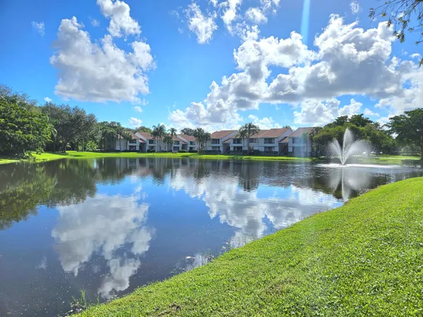 a view of a lake with houses in the back