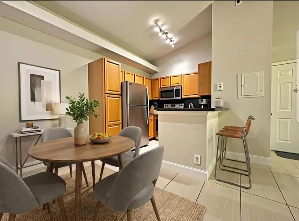 a view of a dining room with furniture and chandelier