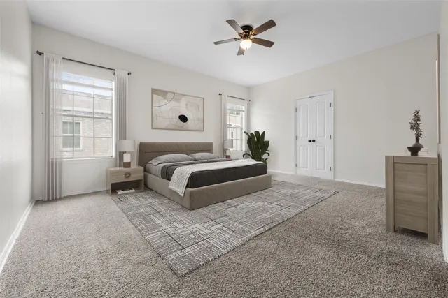 a spacious bedroom with a bed a window and closet