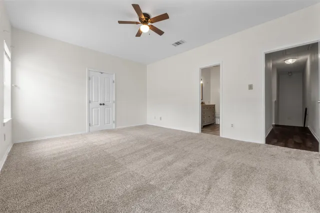 a bathroom with a granite countertop sink a toilet and shower