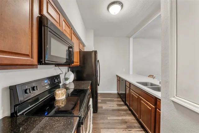 a kitchen with a sink stove and microwave
