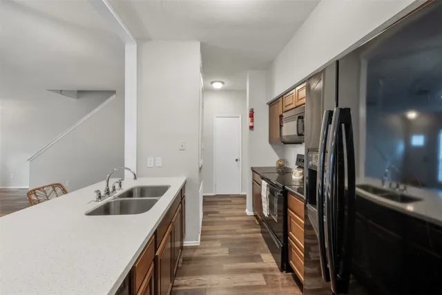 a kitchen with a sink and stainless steel appliances