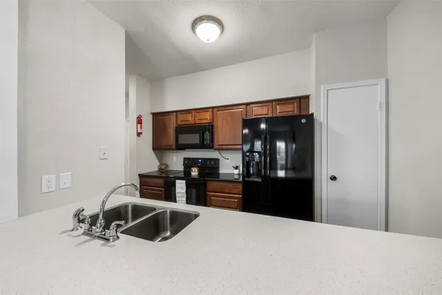 a kitchen with stainless steel appliances a refrigerator and stove