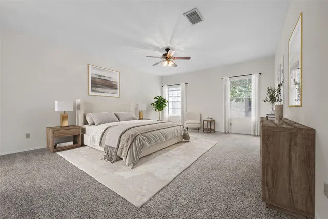 a bedroom with a large bed and a chandelier