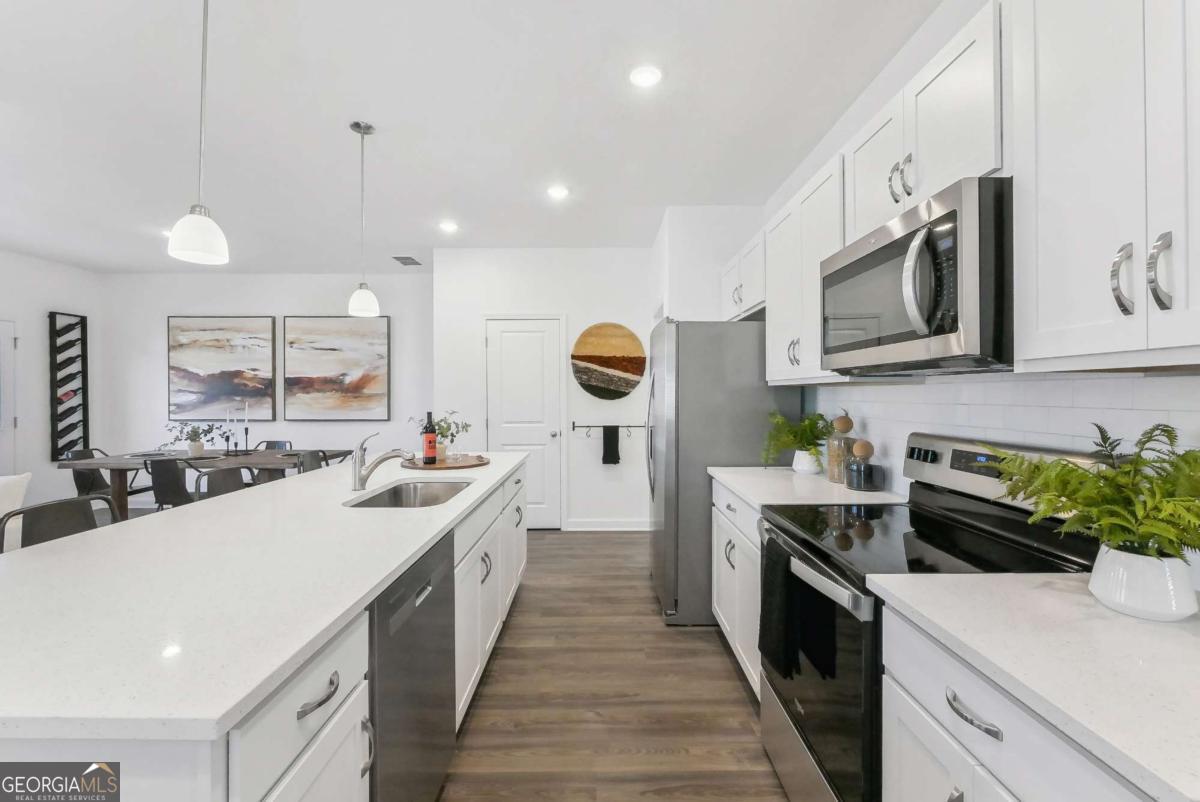 a kitchen with stainless steel appliances granite countertop a sink and stove