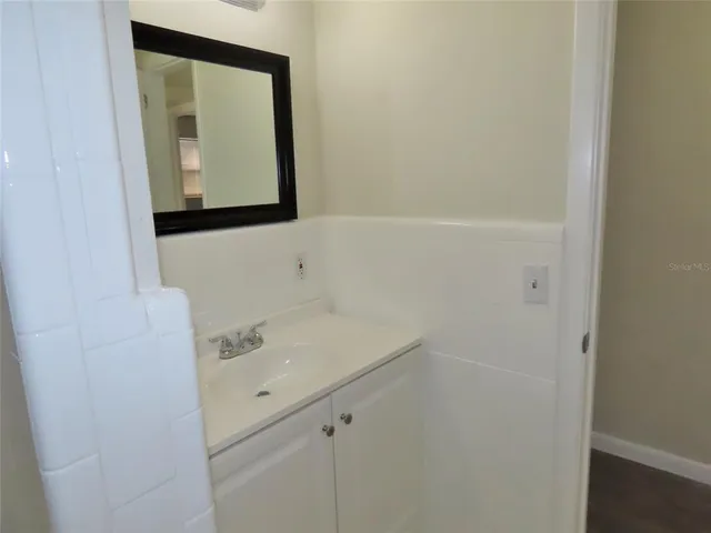 a bathroom with a sink a vanity and mirror