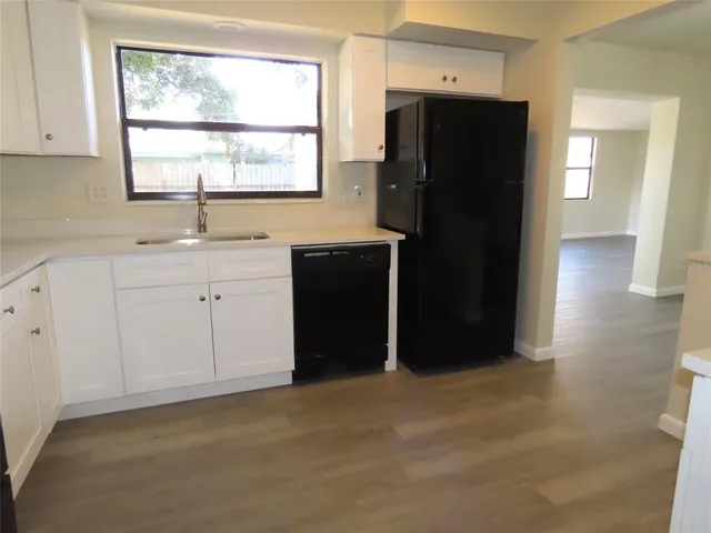 a kitchen with a refrigerator and window