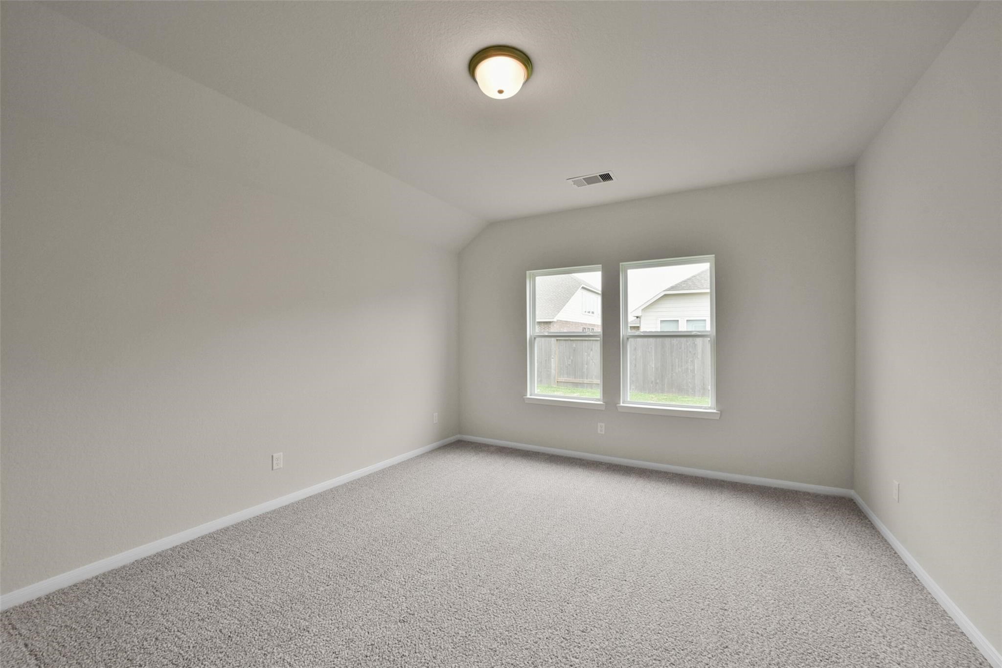 10522 Plumas Run Drive Rosharon, TX 77583 - Photo 12 of 29 This room offers a spacious, neutral-toned interior with plush carpeting and ample natural light from two large windows. Ideal for a bedroom or home office.