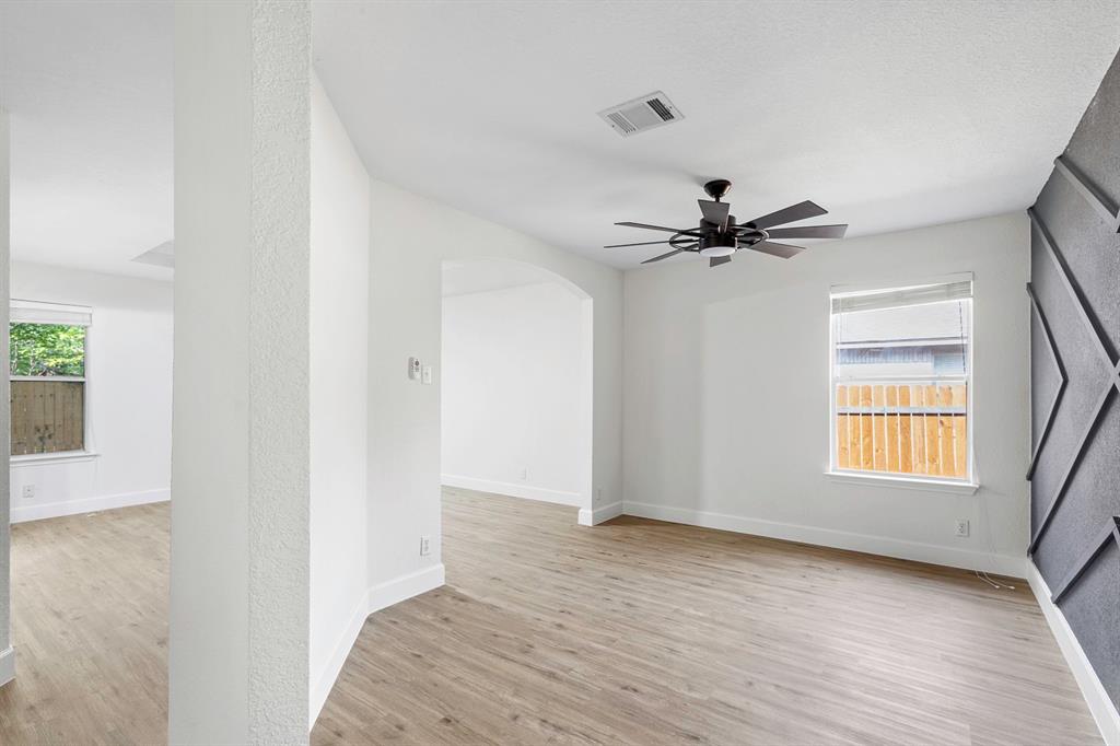 617 Barbara Way Bastrop, TX 78602 - Photo 7 of 20 A versatile living space with light wood-look flooring and a contemporary ceiling fan.